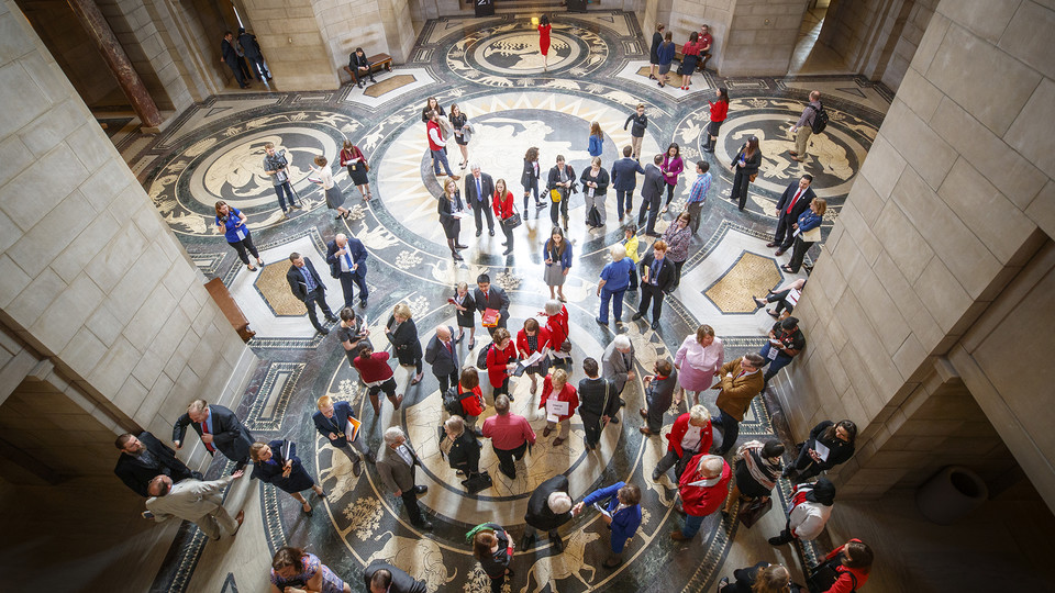 University of Nebraska students, supporters and alumni talk to state senators in the Rotunda Gallery during "I Love NU" Advocacy Day 2019 at the Nebraska State Capitol.