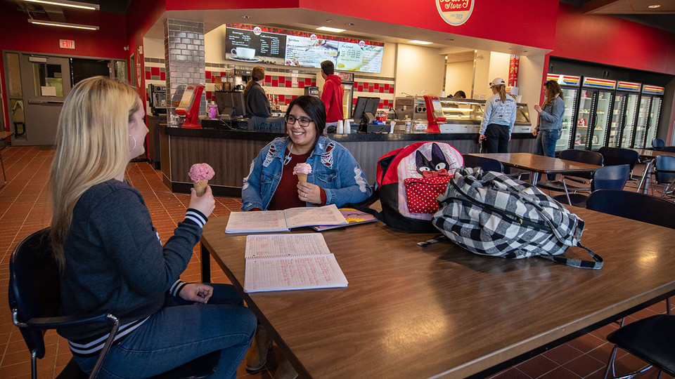 Nikki Holthaus, left, a sophomore marketing major from Elkhorn, and Karla Ortiz, a sophomore elementary education major from South Sioux City, enjoy ice cream at the Dairy Store on Feb. 28. A Dairy Store relocation celebration is planned for 2 to 5 p.m. M