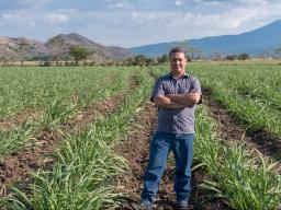 On his farm near Santa Ana, El Salvador, Carlos Martinez stands in a sugarcane field plowed with a tractor and machinery he built. Carlos Eduardo Somoza Vargas