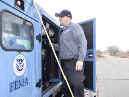 Man standing in front of a FEMA truck.
