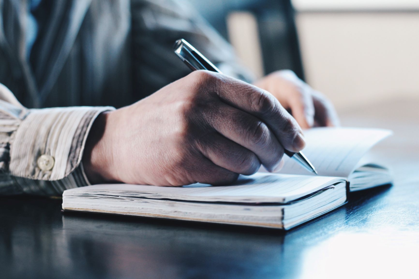 Man writing in notebook