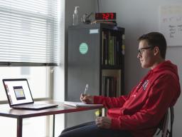 James Wooldridge works on coursework from his Lincoln apartment. Students are encouraged to work with their career coach remotely to continue their career development. (James Wooldridge | University Communication) 