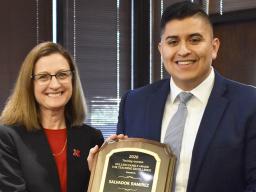 Betty Walter-Shea, CASNR interim associate dean, presents Salvador Ramirez with the Holling Family Teaching Assistant Teaching Excellence award March 11 at the Nebraska East Union.
