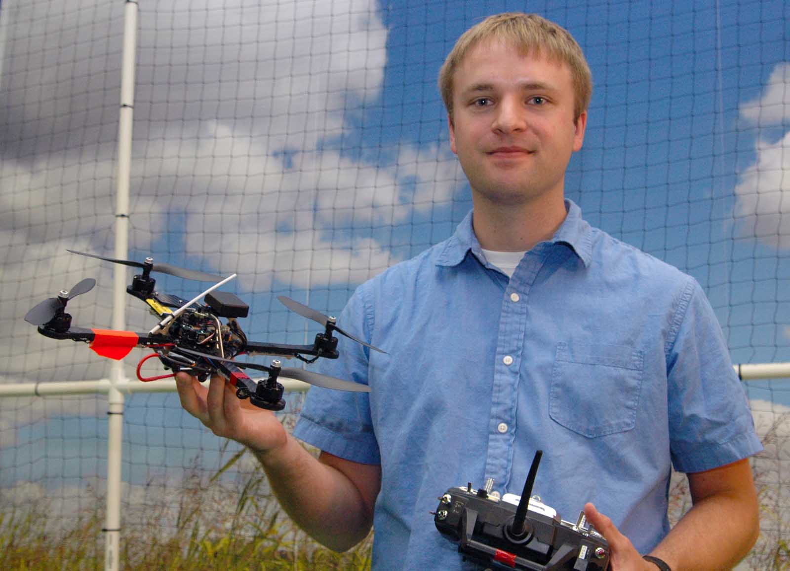 Carrick Detweiler holds a quadrotor robot and controller in UNL's NIMBUS lab. The robots will be featured in two Oct. 12 performances at the Lied Center for Performing Arts.