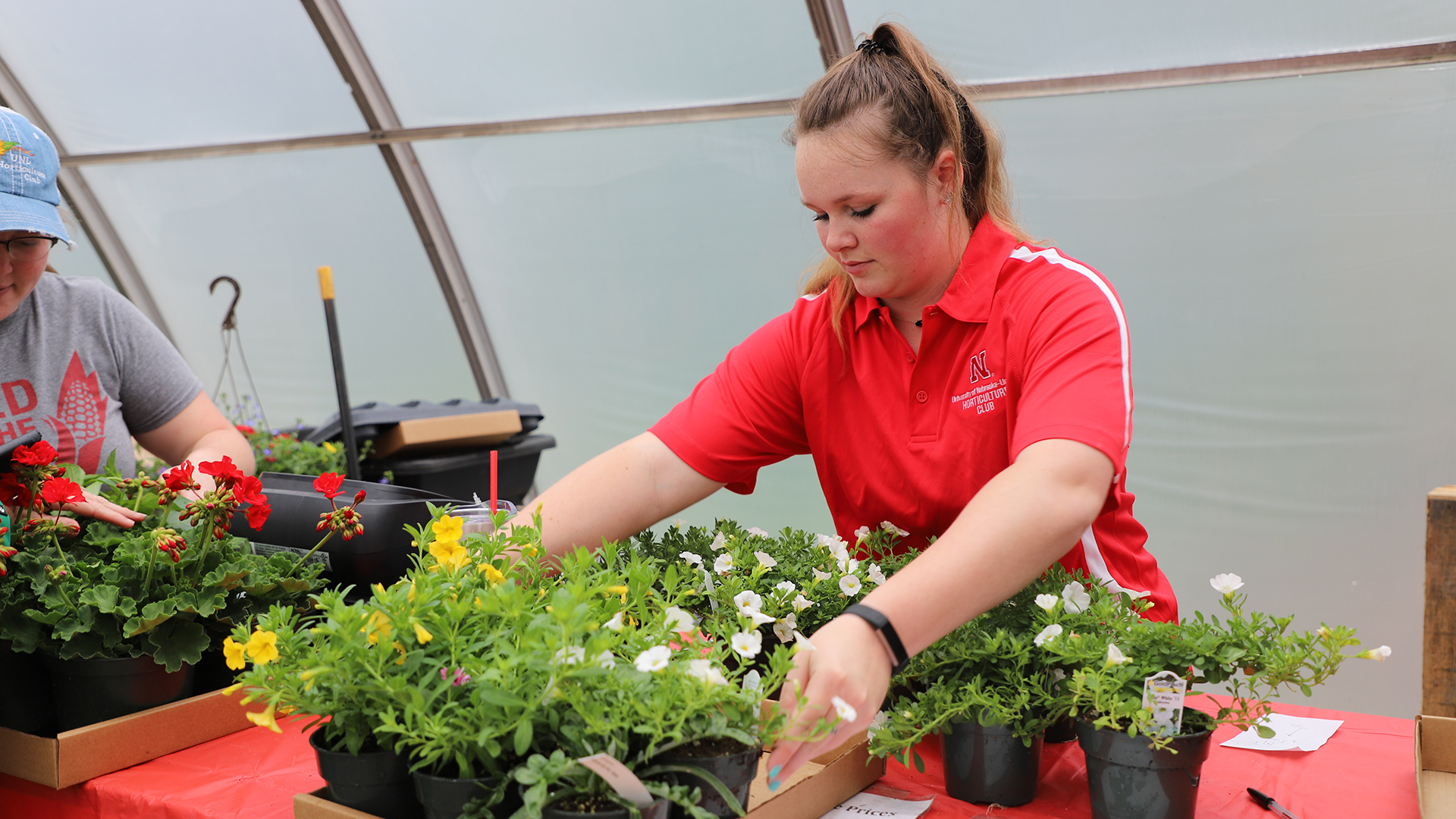 Horticulture club members, Morgan Von Seggern (left) and Haley Donaldson prepare flats of plants for customers at the 2019 spring sale.