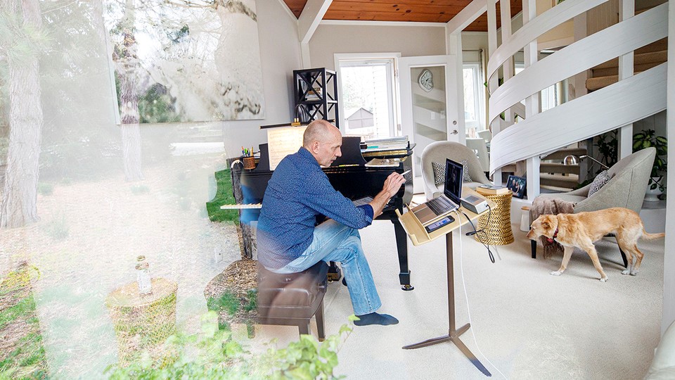 Nebraska’s Paul Barnes sits at the Steinway piano in his home while teaching a one-on-one lesson with student Cameron Berta, who returned home to Dallas in the wake of the university's shift to remote instruction. Credit: Craig Chandler.