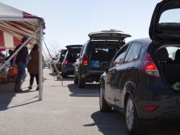 Clients at the Center for People in Need wait in the distribution drive-thru.