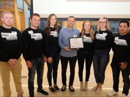 The Bay's Executive Director, Andrew Norman, accepts a grant from Fall 2019 students at the Awards Ceremony.