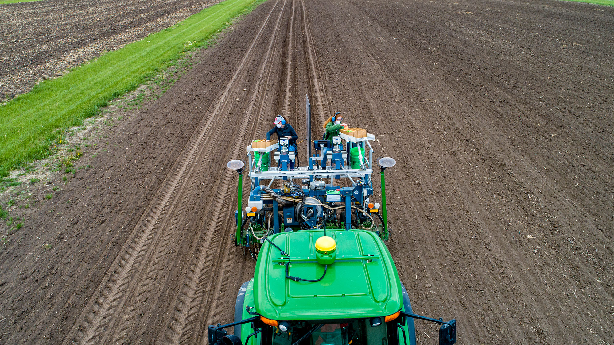 Brandi Simon (left), assistant professor of practice in plant pathology, along with research manager Christine Smith, use a mechanical planter to distribute corn and sorghum seeds at the university's Havelock Farm in northeast Lincoln. Craig Chandler | Un