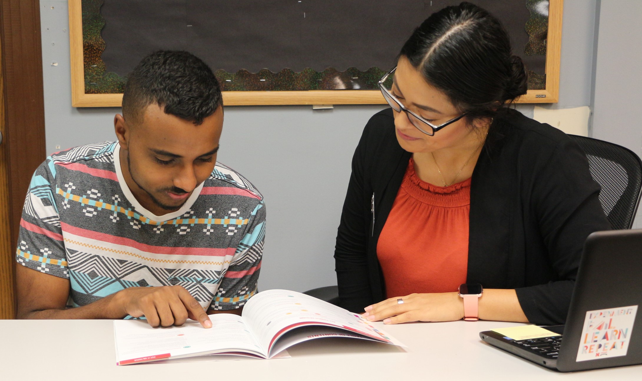 Career Advisor Letty Garcia helps a student develop his resume.