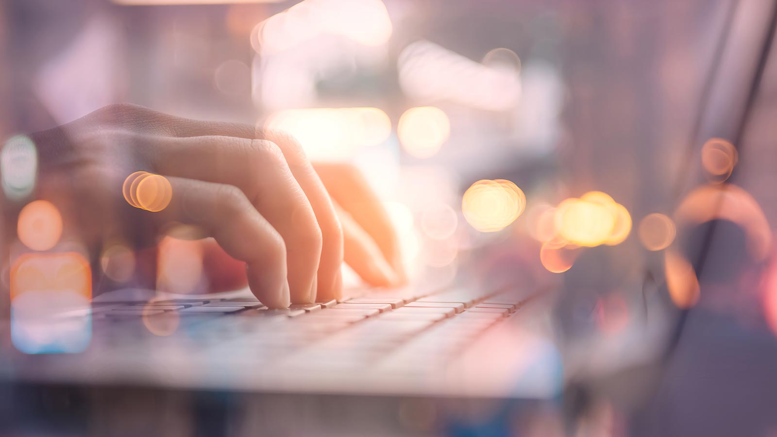 Hands typing on computer keyboard