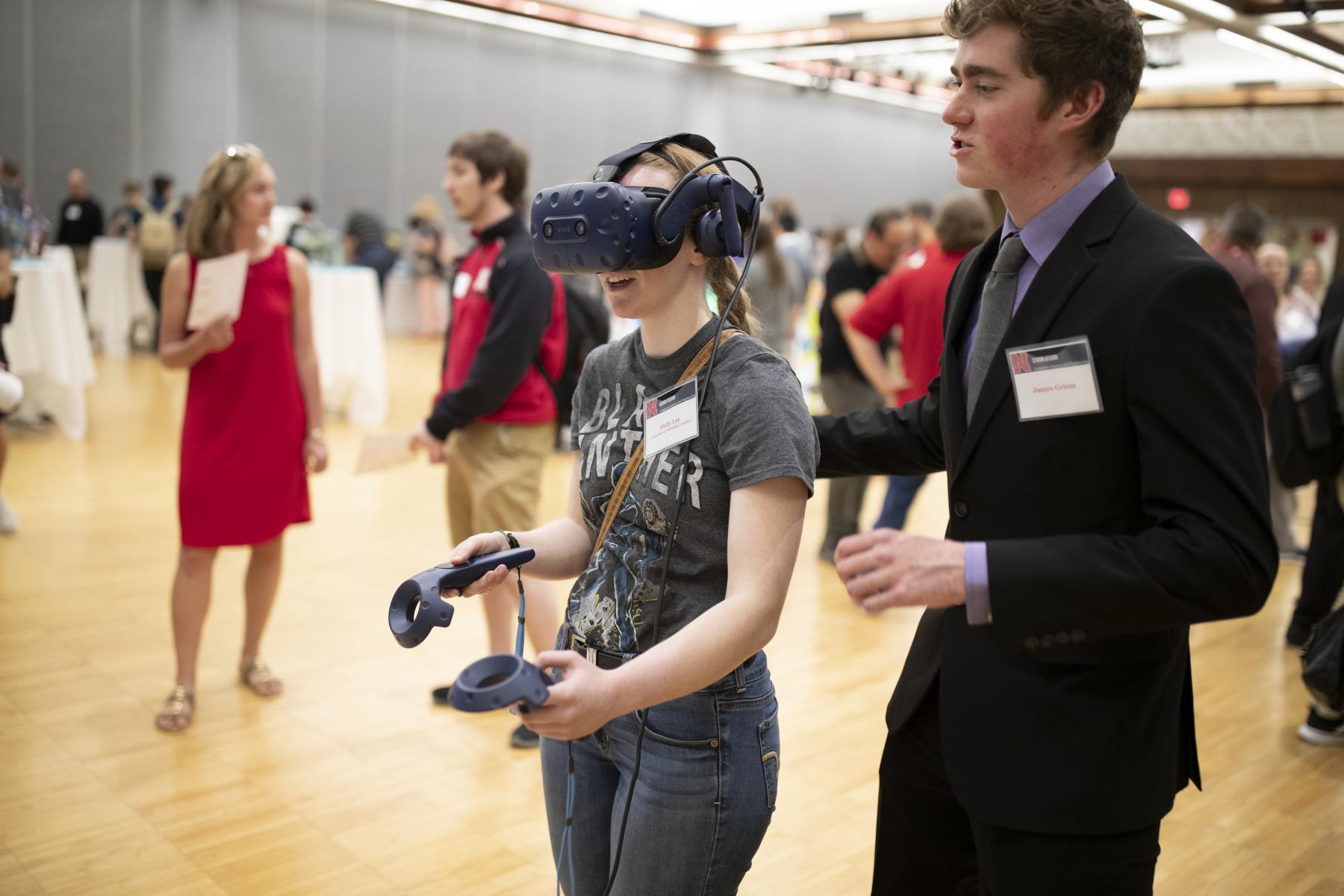 A student demos a VR project at the 2019 Senior Design Showcase.