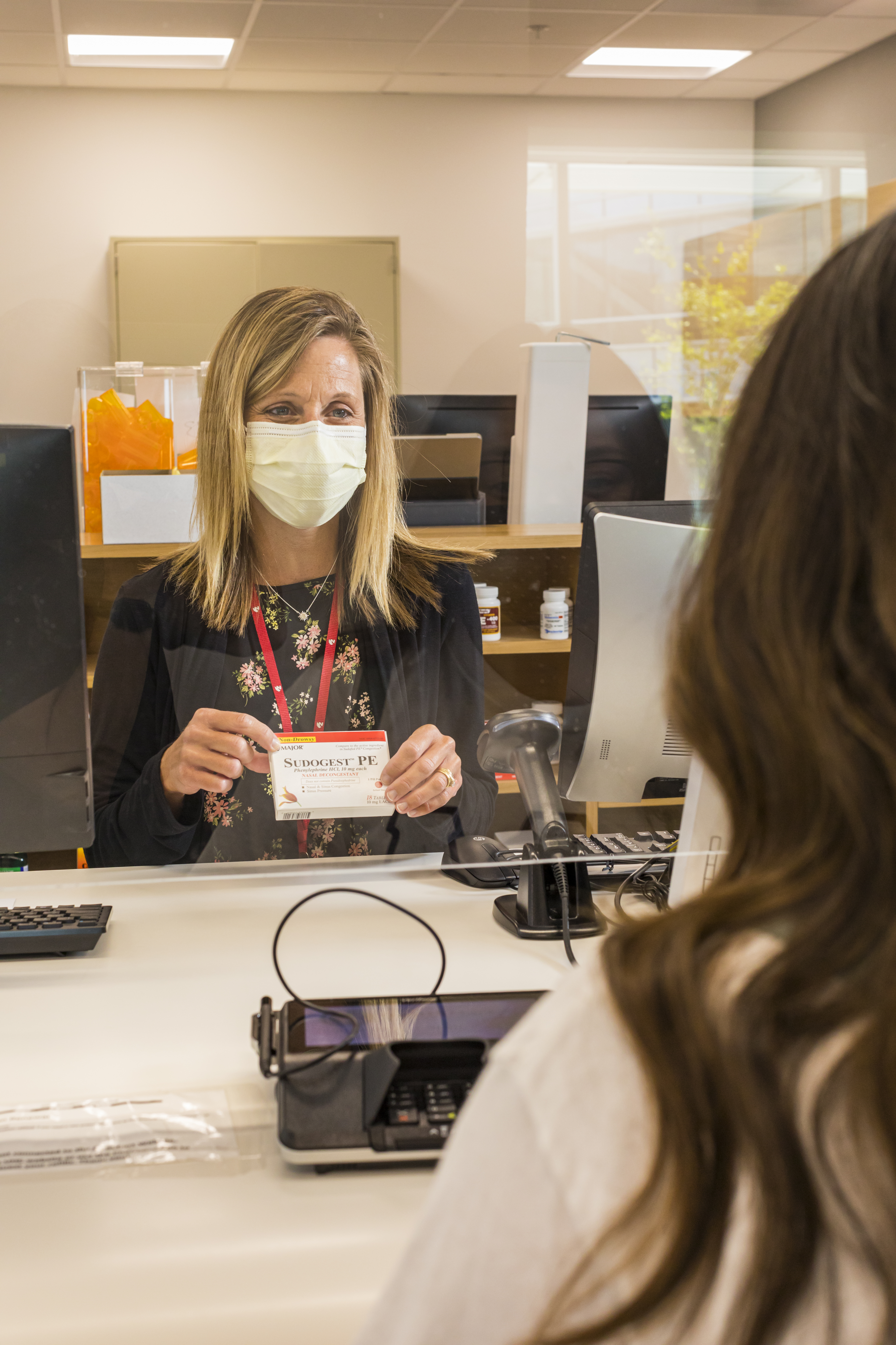 Student selects over-the-counter medicine at the University Health Center pharmacy.