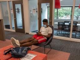 Tedum Npimnee, a junior international business major, waits for an appointment in the new Husker Hub office in Canfield Administration Building. Previously located in Pound Hall, Husker Hub recently moved into its remodeled space. 