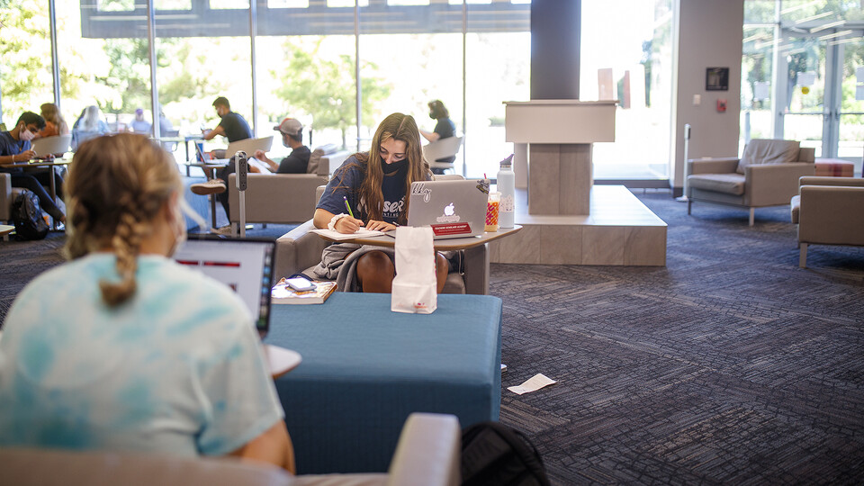 Huskers work in the Adele Hall Learning Commons between classes during the fall semester's first day of in-person instruction. To help keep the campus community safe, facial coverings are to be worn jat all times indoors and when six-foot distancing canno