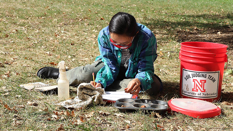 Phuong Minh Tu Le makes notes about her soil texture and soil color determinations during an Oct. 2 practice session in advance of the Region 5 Soil Judging Competition. The competition is being held virtually this year. Lana Johnson | UNLAgroHort