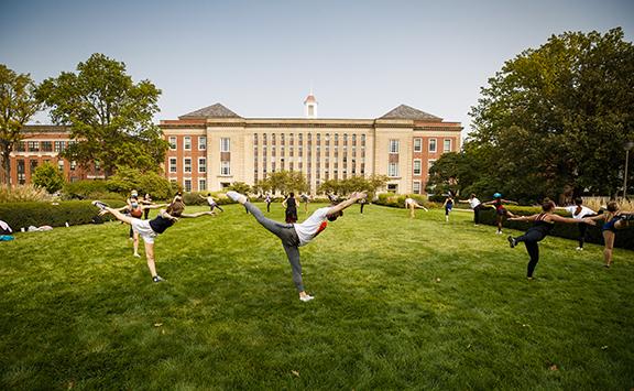 Students in a modern dance class led by Susan Ourada practice on the green space south of Love Library on Sept. 17. Support from donors has helped remove the university’s dance program from a list of proposed budget reductions. Photo by Craig Chandler, Un