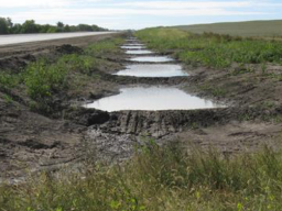 Earth check sediment control strategy in use in a roadway ditch.