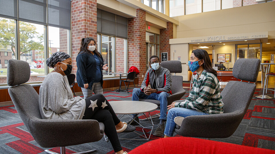 Brannon Evans (left) Dulce Garcia, Salman Djingueinabaye and Daniela Chavez, the executive team of the new Dr. Michael W. Combs Honors Scholars — Combs Honors Scholars for short — talk in the lobby of Knoll Residential Center.  [Craig Chandler | Universit