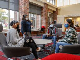 Brannon Evans (left) Dulce Garcia, Salman Djingueinabaye and Daniela Chavez, the executive team of the new Dr. Michael W. Combs Honors Scholars — Combs Honors Scholars for short — talk in the lobby of Knoll Residential Center.  [Craig Chandler | Universit