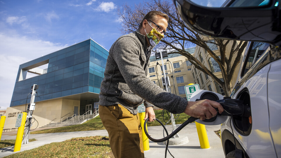 Dan Carpenter, director of Parking and Transit Services, plugs in a Chevy Bolt at a new charging station in front of Howard L. Hawks Hall. The University of Nebraska–Lincoln has six new charging stations for electric vehicles across City and East Campus.