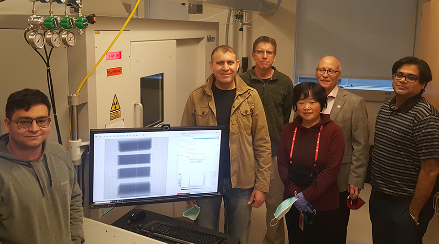 Researchers from the Nano-engineering Research Core Facility (NERCF) – (from left) Andrew Menendez, Ziyad Smoqi, Jeff Shield, Wen Qian, Joseph Turner, Prahalada Rao – stand with the new Nikon X-Ray Computed Tomography machine that can make high-powered, 3