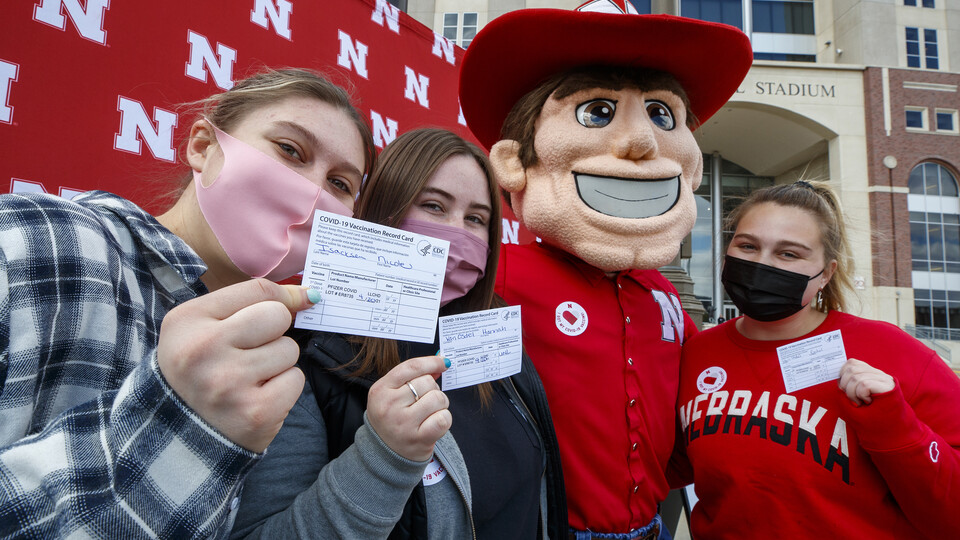 Students pose with Herbie Husker after getting vaccinated in a Pfizer clinic on April 20.