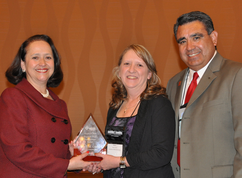 UNL's Mary Guest (center) receives the NASPA award from Patricia Telles-Irvin, NASPA president, and Timothy Alvarez, UNL's assistant vice chancellor for student affairs.