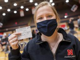 Nebraska's Whitney Steckel displays her vaccine card after getting her first inoculation during an on-campus clinic on April 20.