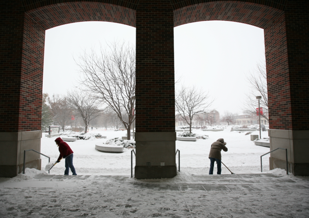 UNL employees scoop snow outside the Nebraksa Union.