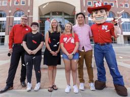 Jenna Huttenmaier (third from left) won the vaccine registry giveaway grand prize, a trip for two with Chancellor Ronnie Green (left) to a 2022 Husker football game in Ireland. (University Communication)
