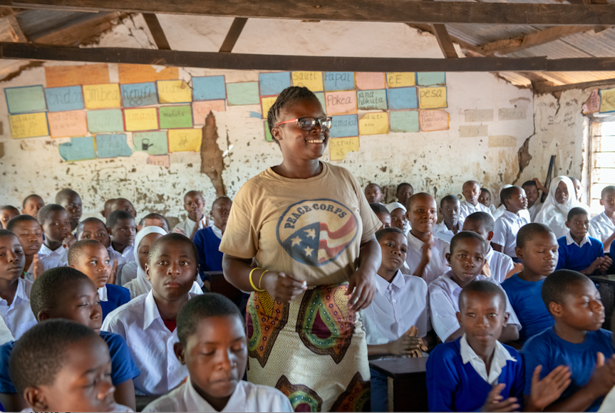 A Peace Corps volunteer teaches a classroom of young children in Tanzania. © PEACE CORPS, Tanzania & Education 
