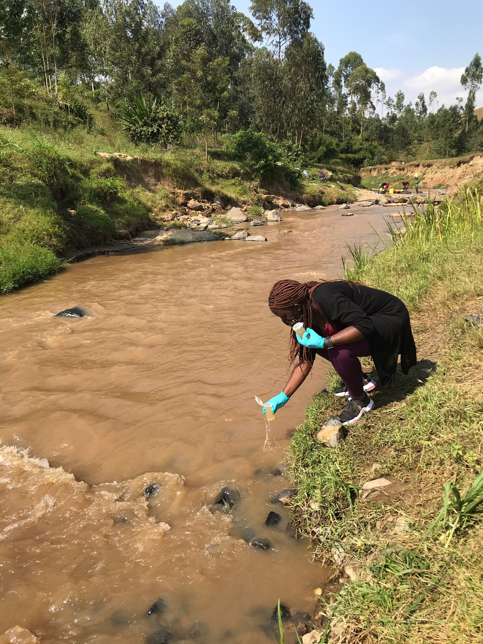 An undergraduate student Andy Uwase collected surface water samples in western Rwanda for water quality testing. ©UNMC. 