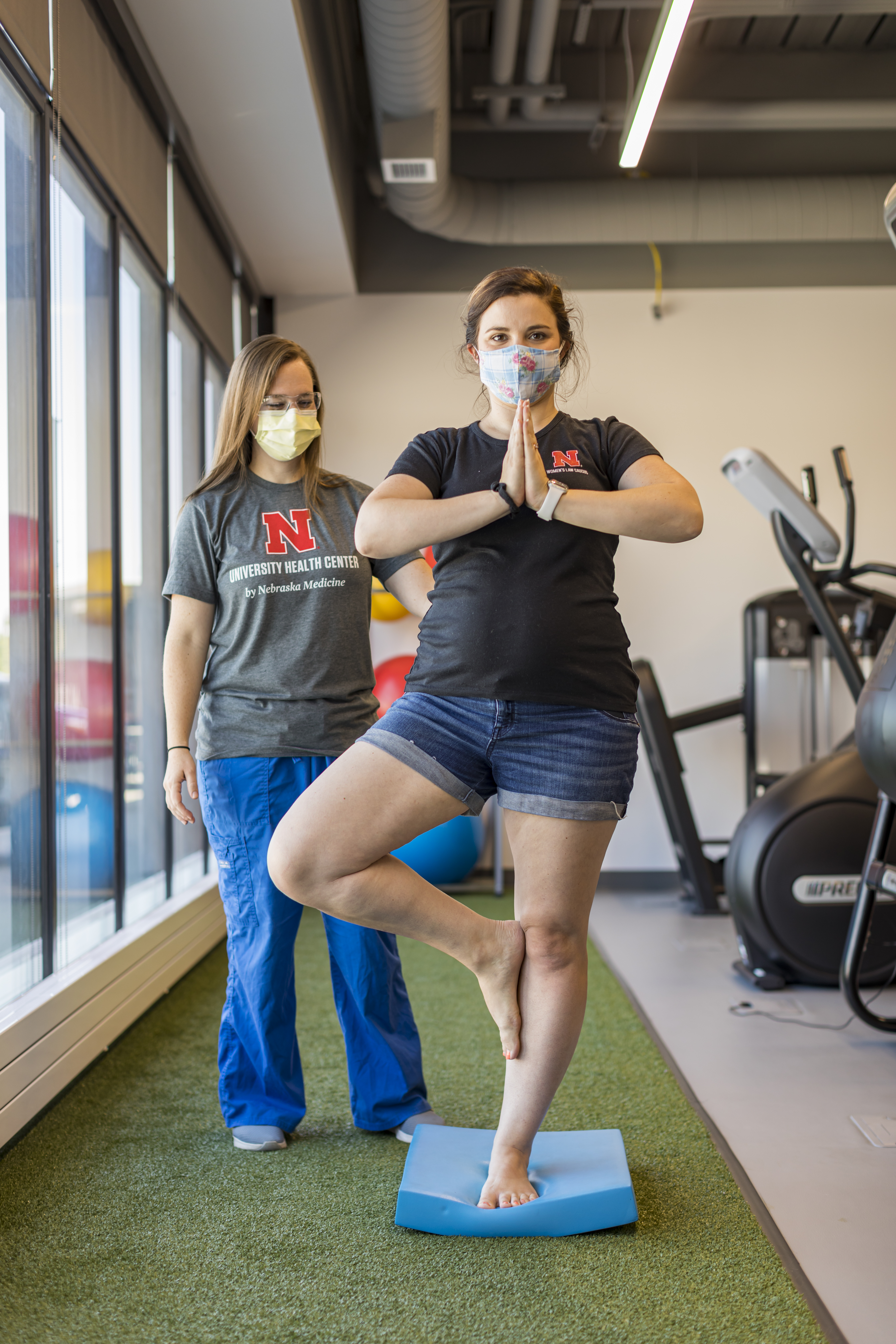 Physical Therapist Kelsey Gaston guides a student through a balance exercise.