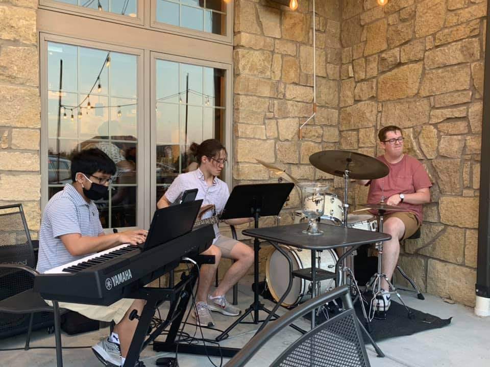The Prism Trio (Andrew Wray, Sean Lebita, and Jonah Bennett) performing at a recent show