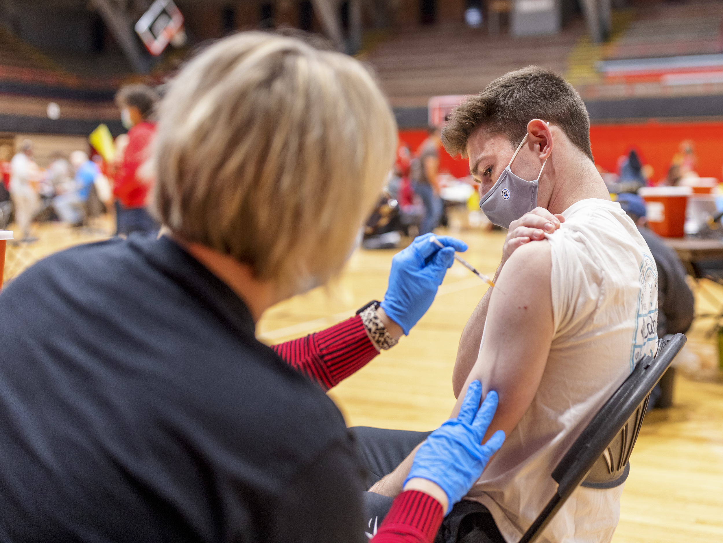 A student receives their first dose of COVID during a clinic in April 2021. [Photo by Craig Chandler | University Communication]