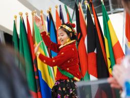 Sandhya Karki, senior from Nepal, performs a traditional dance from her country during the signature International Education Week event, Global Cafe and Connections.