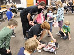 Pictured are members of the N-Bots club demonstrating their programmed competition robots to members of the Clover Kids club.