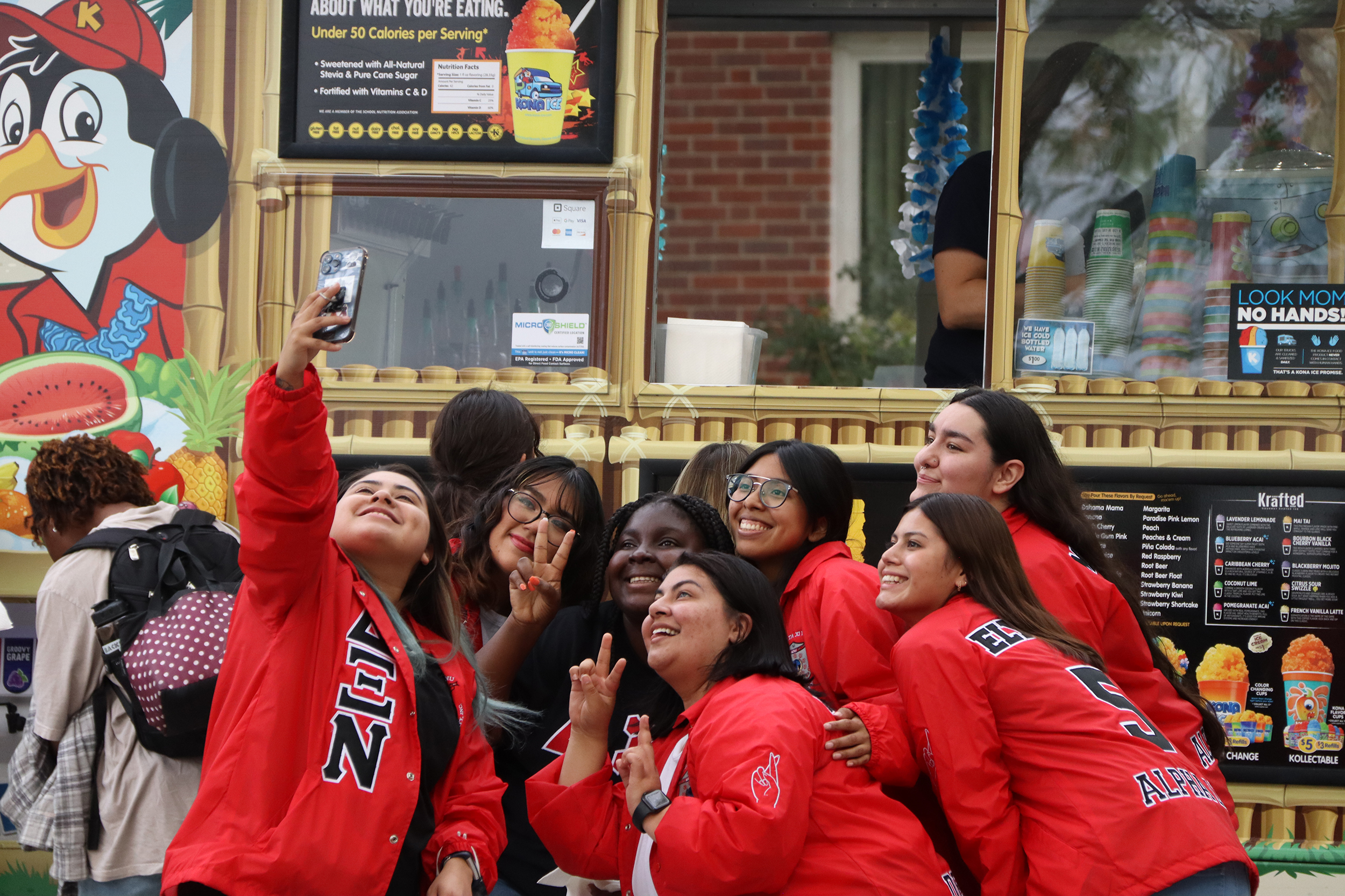 Sorority members pose for a group selfie at MGC & NPHC: Back to School Block Party.