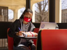 Students Gabriella Silva (red mask) and Zoe Keese (white mask) study at the tables in the sun lit lobby inside Hamilton Hall during the spring 2021 semester. The university will open the spring 2022 semester on Jan. 18 with updated COVID-19 protocols.