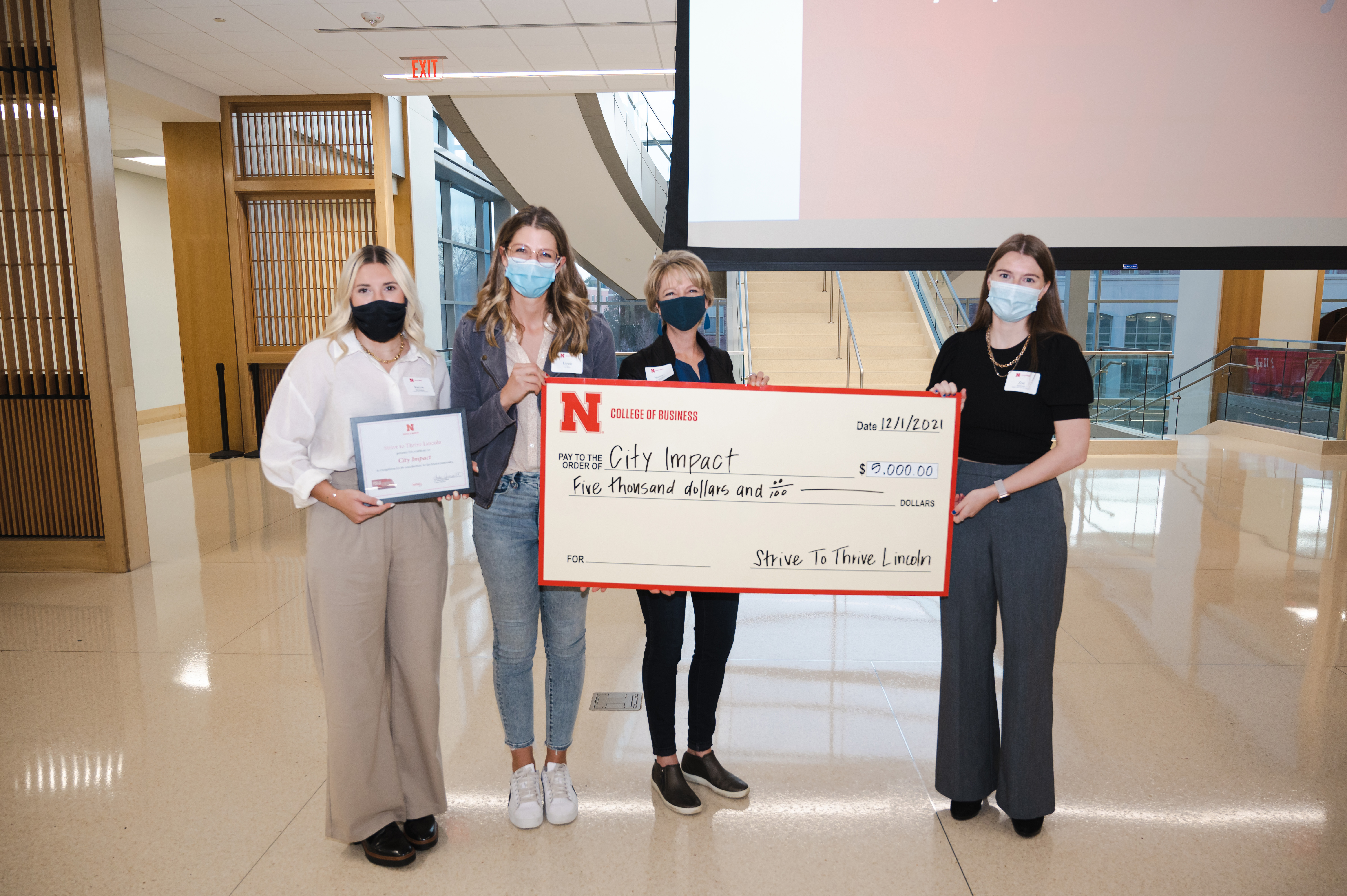 CEDARS check presentation by Paxton Brittingham (far left) and Zoe Matheson (far right) to Executive Lizzie Mattox and Development Director Nancey BernhardsonChristina Lloyd