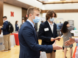 A marketing student talks with recruiters at the fall 2021 Career Fair. [Craig Chandler | University Communication]