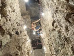 Heather Richards-Rissetto scales a ladder to go deeper into Tunnel 16.