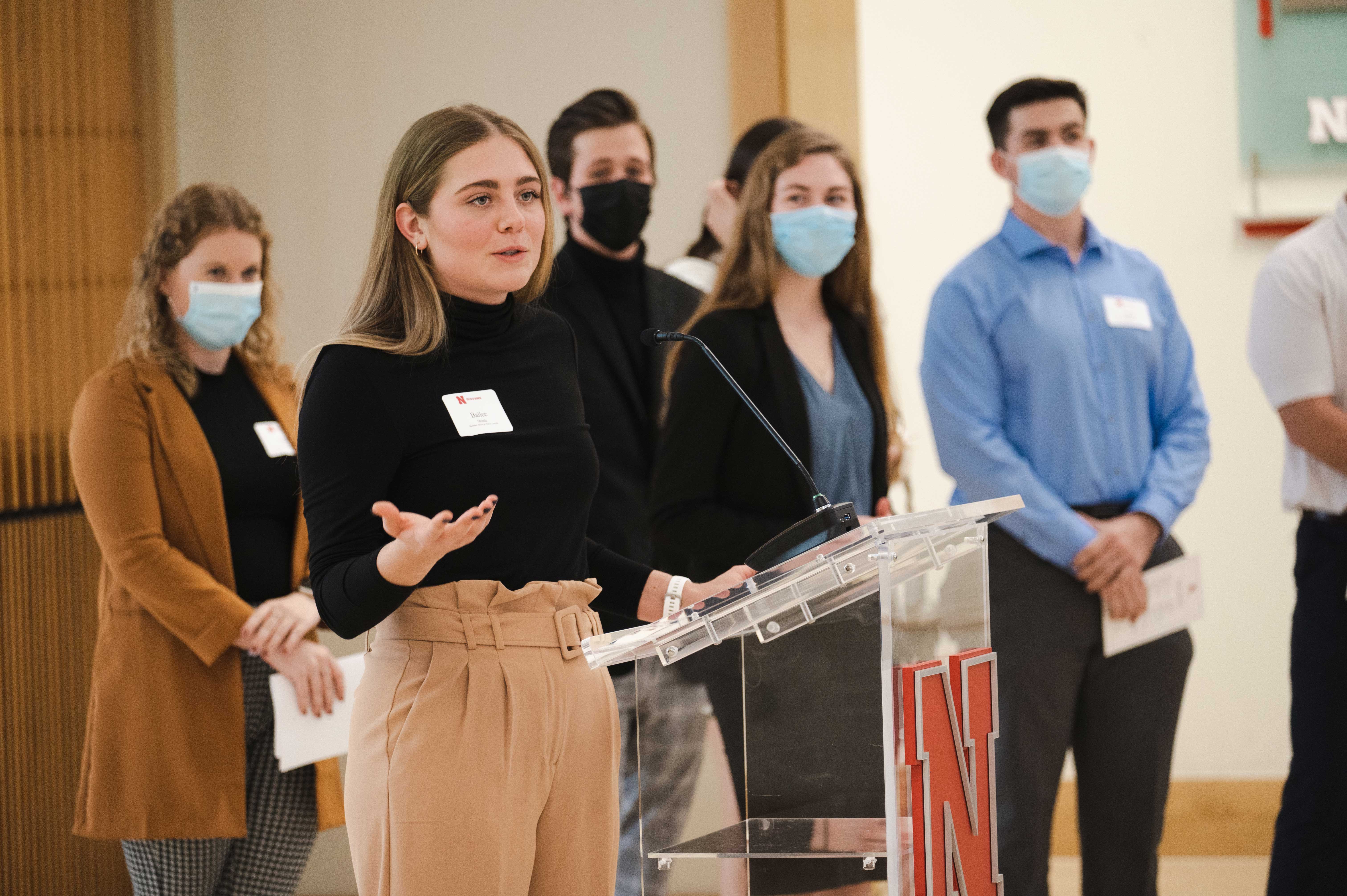 Bailee Steinle, MNGT 411 member, shares the accomplishments of her task group at the Grant Ceremony.