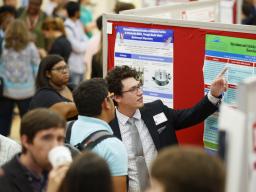 A student presents research at the Nebraska Summer Research Symposium in 2019.// University Communications