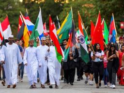 More than 100 international students marched under the flags of their nations during the university's 2021 homecoming parade. University leaders recently completed a realignment of internationally-focused units. The newly renamed Global Affairs umbrella w
