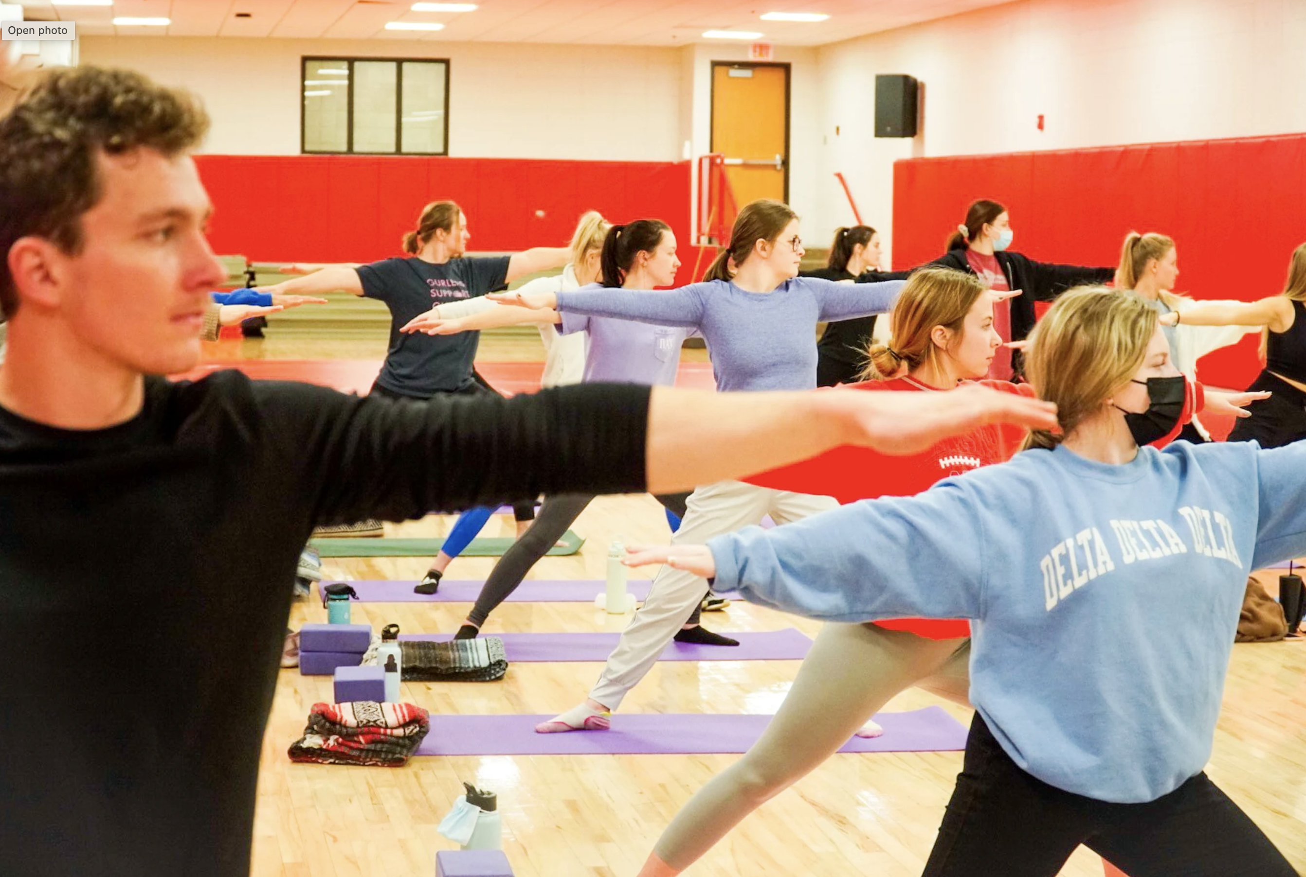 Students participate in a guided group yoga and meditation practice in the Campus Recreation Center Fitness Room.