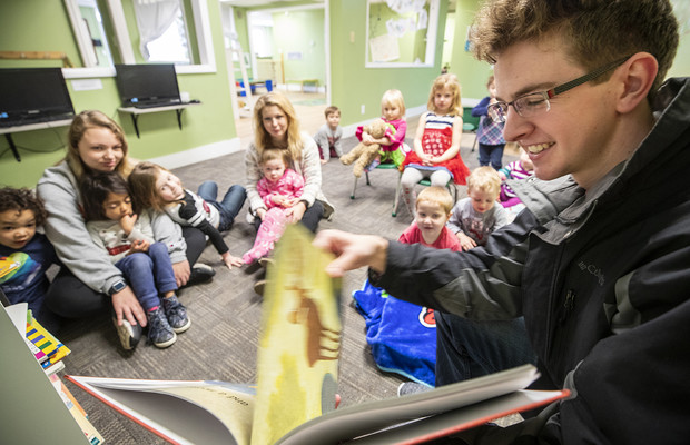 Thomas Kerr, a senior accounting major from Hastings, reads to children at the Foundations Progressive Learning Center during the Husker Reading Challenge.