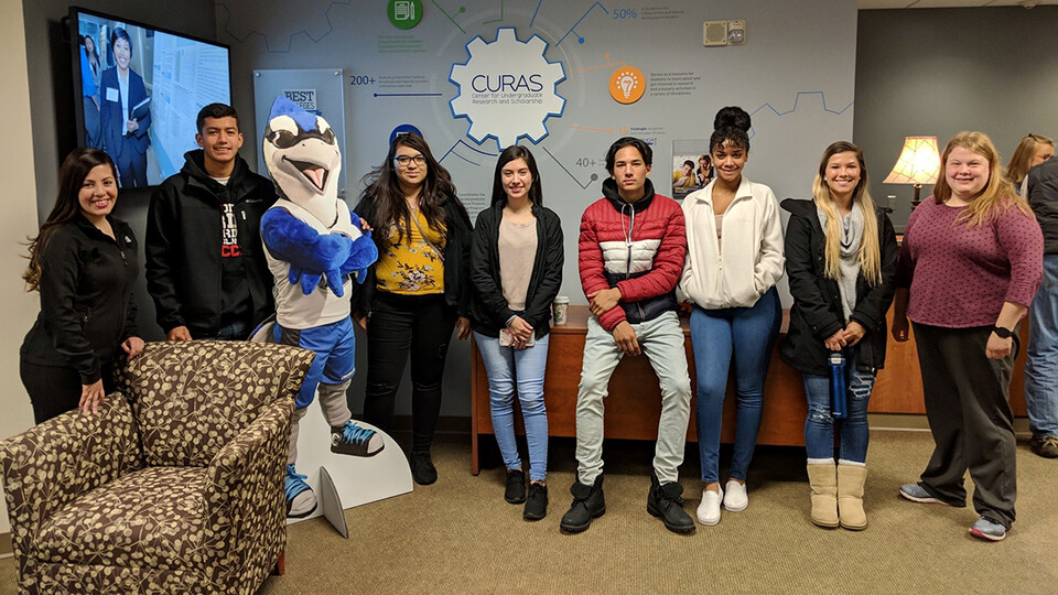 Selma De Anda Gallegos (left) poses with Lincoln High School students during a tour of Creighton University.