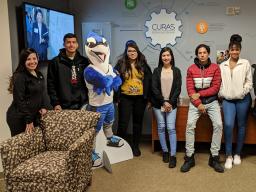 Selma De Anda Gallegos (left) poses with Lincoln High School students during a tour of Creighton University.